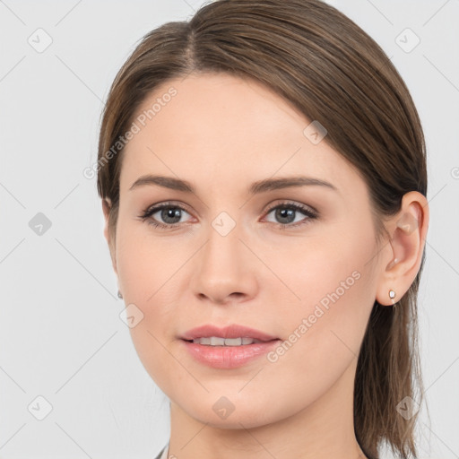 Joyful white young-adult female with long  brown hair and grey eyes