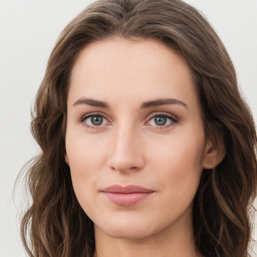 Joyful white young-adult female with long  brown hair and green eyes