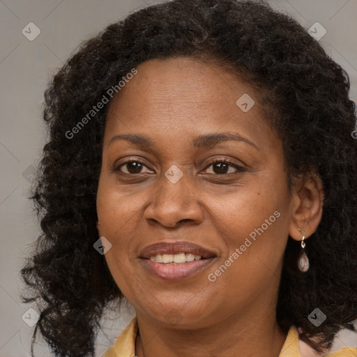 Joyful black adult female with medium  brown hair and brown eyes