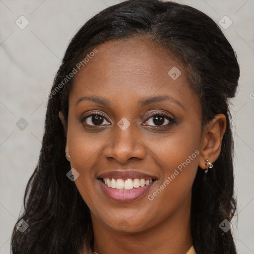 Joyful black young-adult female with long  brown hair and brown eyes