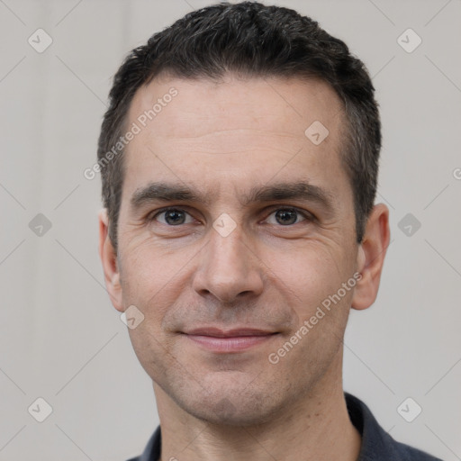 Joyful white adult male with short  black hair and brown eyes