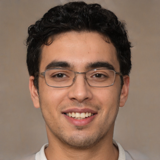 Joyful white young-adult male with short  black hair and brown eyes