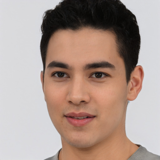Joyful asian young-adult male with short  black hair and brown eyes
