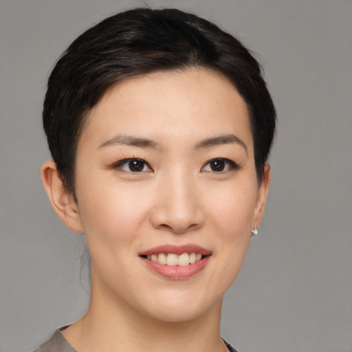 Joyful asian young-adult female with short  black hair and brown eyes