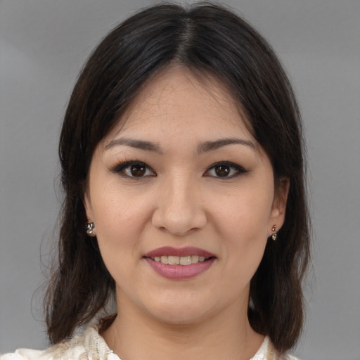 Joyful white young-adult female with medium  brown hair and brown eyes
