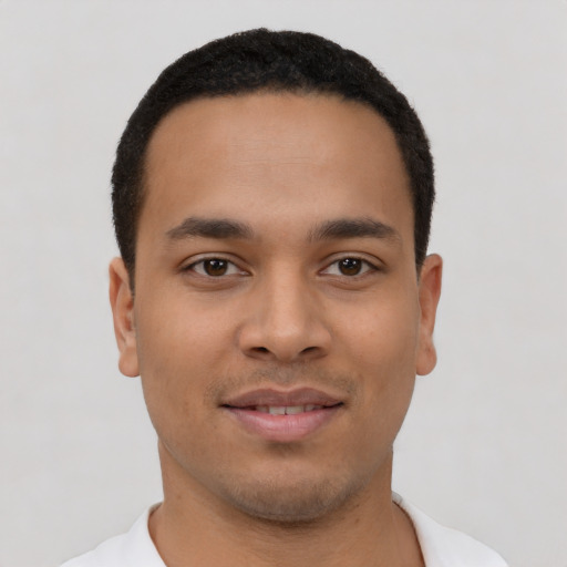 Joyful latino young-adult male with short  black hair and brown eyes