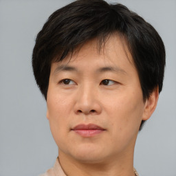 Neutral asian adult male with short  brown hair and brown eyes