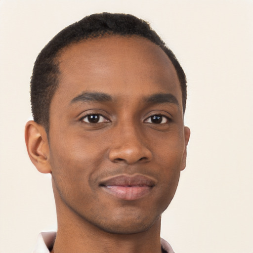 Joyful black young-adult male with short  brown hair and brown eyes