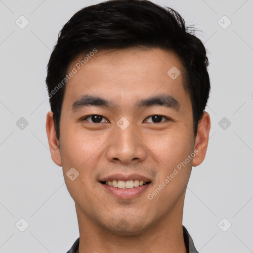 Joyful asian young-adult male with short  black hair and brown eyes