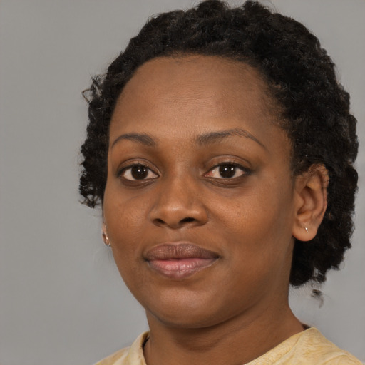 Joyful black young-adult female with medium  black hair and brown eyes