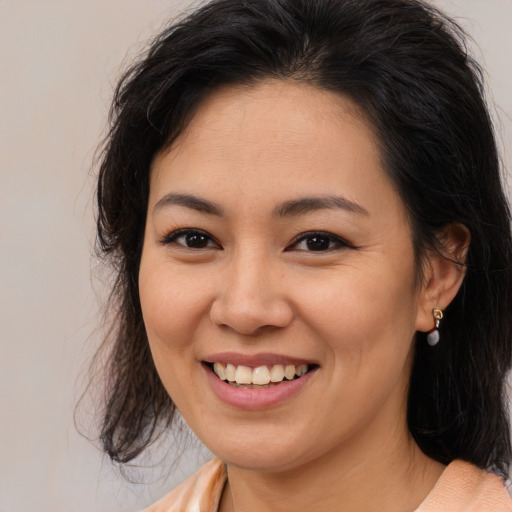 Joyful asian young-adult female with medium  brown hair and brown eyes