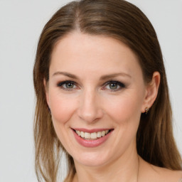 Joyful white young-adult female with long  brown hair and grey eyes