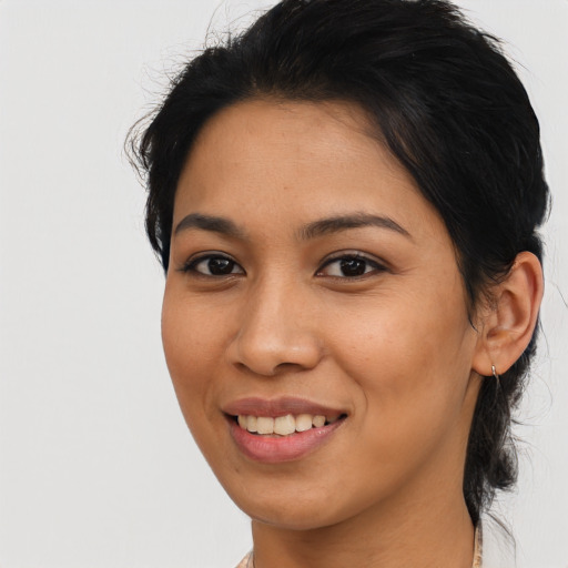 Joyful latino young-adult female with medium  black hair and brown eyes