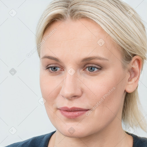 Joyful white young-adult female with medium  brown hair and blue eyes