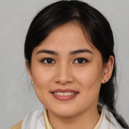 Joyful latino young-adult female with medium  brown hair and brown eyes