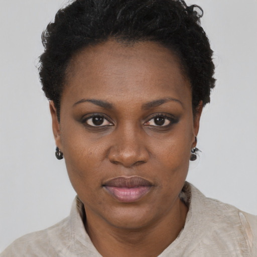 Joyful black adult female with short  black hair and brown eyes