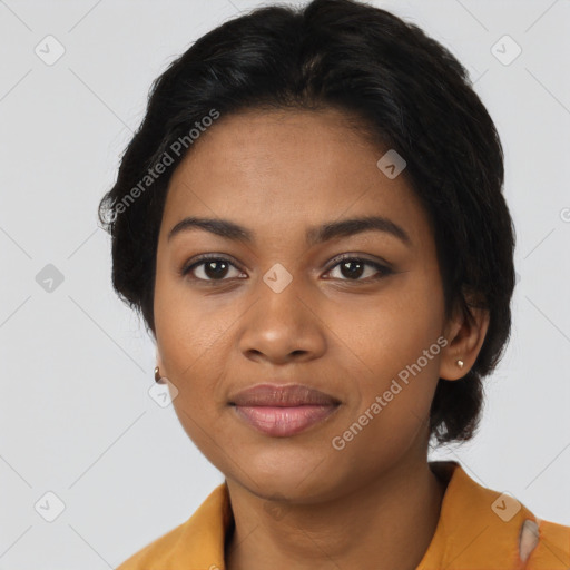 Joyful black young-adult female with long  black hair and brown eyes