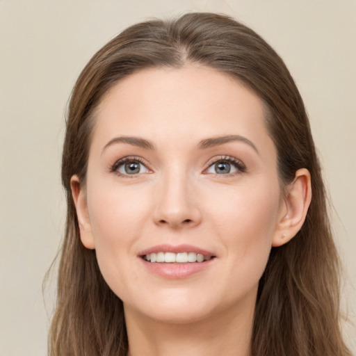 Joyful white young-adult female with long  brown hair and grey eyes