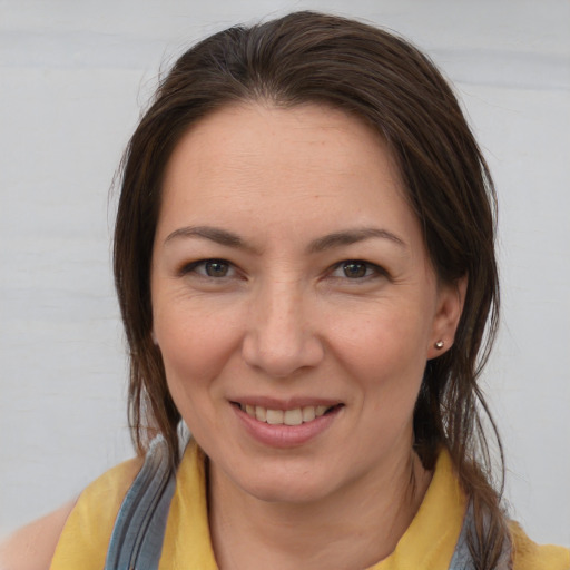 Joyful white young-adult female with medium  brown hair and brown eyes