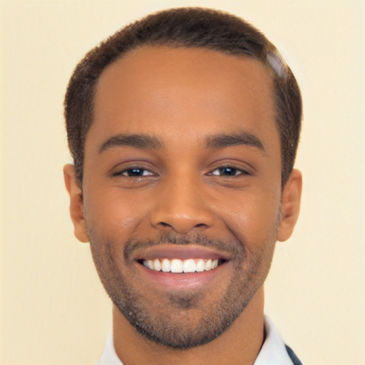 Joyful black young-adult male with short  brown hair and brown eyes