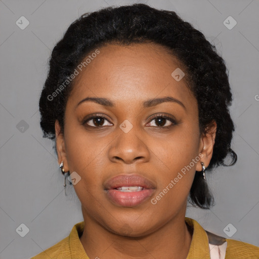 Joyful black young-adult female with short  black hair and brown eyes