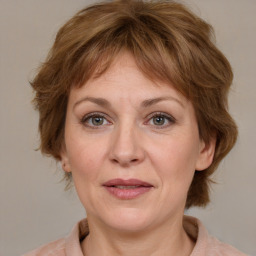 Joyful white adult female with medium  brown hair and grey eyes