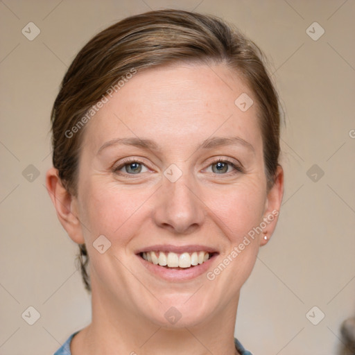 Joyful white adult female with medium  brown hair and blue eyes