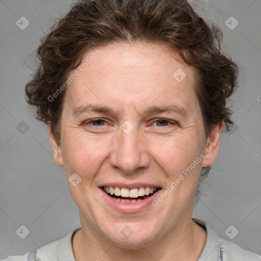 Joyful white adult female with short  brown hair and grey eyes