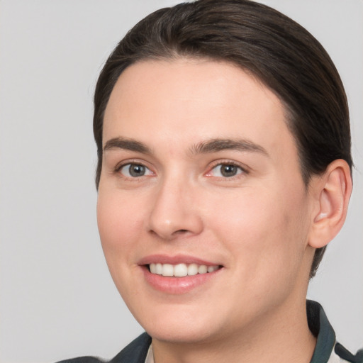 Joyful white young-adult female with short  brown hair and brown eyes