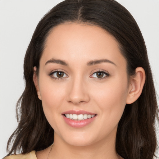 Joyful white young-adult female with long  brown hair and brown eyes