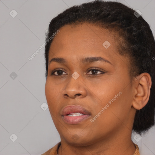 Joyful black young-adult female with short  black hair and brown eyes