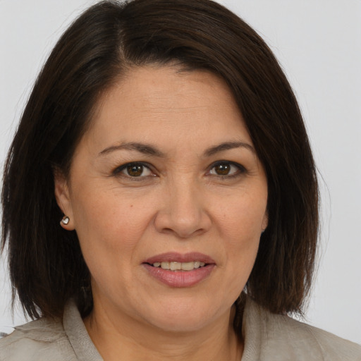 Joyful white adult female with medium  brown hair and brown eyes