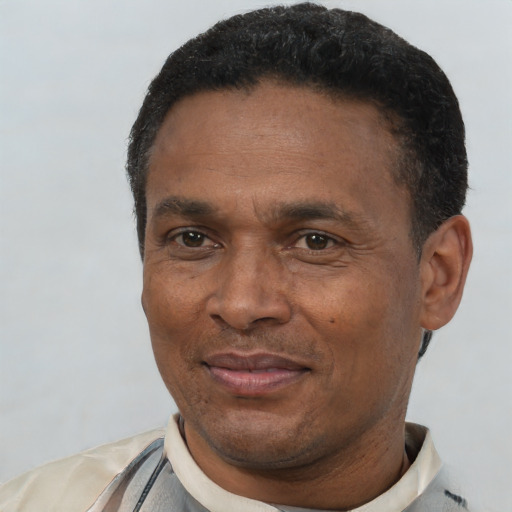 Joyful latino adult male with short  black hair and brown eyes