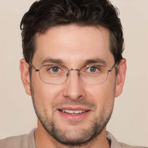 Joyful white adult male with short  brown hair and brown eyes