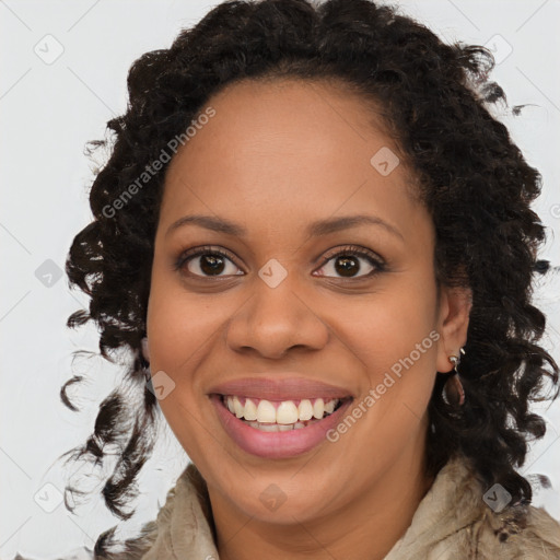 Joyful black young-adult female with long  brown hair and brown eyes