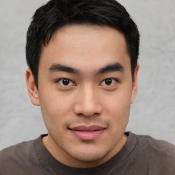 Joyful asian young-adult male with short  black hair and brown eyes