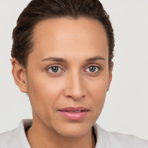 Joyful white young-adult female with short  brown hair and brown eyes