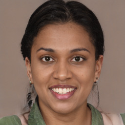 Joyful black young-adult female with medium  brown hair and brown eyes