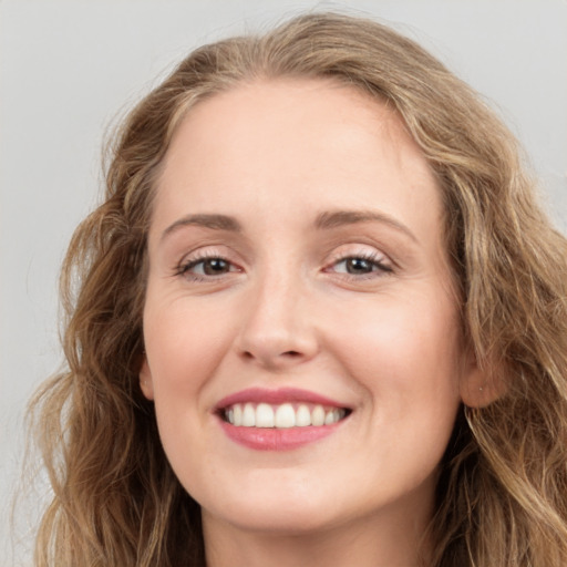 Joyful white young-adult female with long  brown hair and green eyes