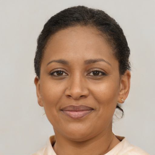Joyful latino adult female with short  brown hair and brown eyes