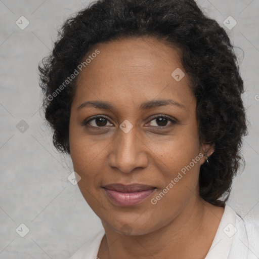 Joyful black adult female with medium  brown hair and brown eyes