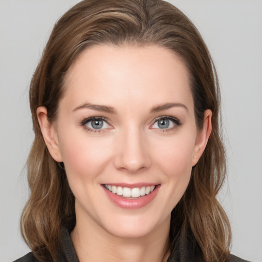 Joyful white young-adult female with long  brown hair and grey eyes