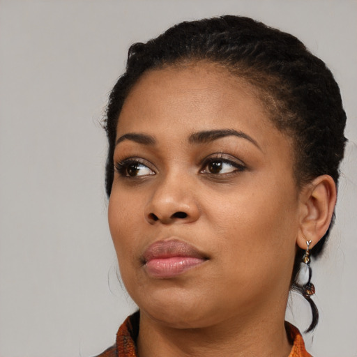 Joyful black young-adult female with medium  black hair and brown eyes