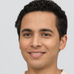 Joyful latino young-adult male with short  brown hair and brown eyes