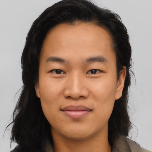 Joyful asian young-adult female with long  black hair and brown eyes