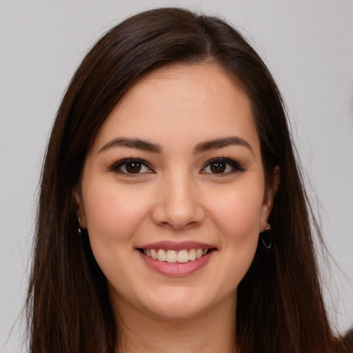 Joyful white young-adult female with long  brown hair and brown eyes