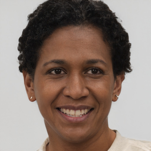 Joyful black adult female with short  brown hair and brown eyes