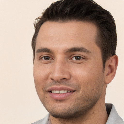 Joyful white young-adult male with short  brown hair and brown eyes