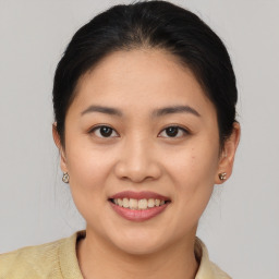 Joyful asian young-adult female with medium  brown hair and brown eyes