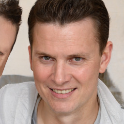 Joyful white adult male with short  brown hair and brown eyes